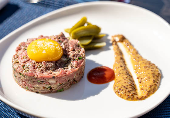 Steak tartare served with an egg yolk and sauce in the Oak Room